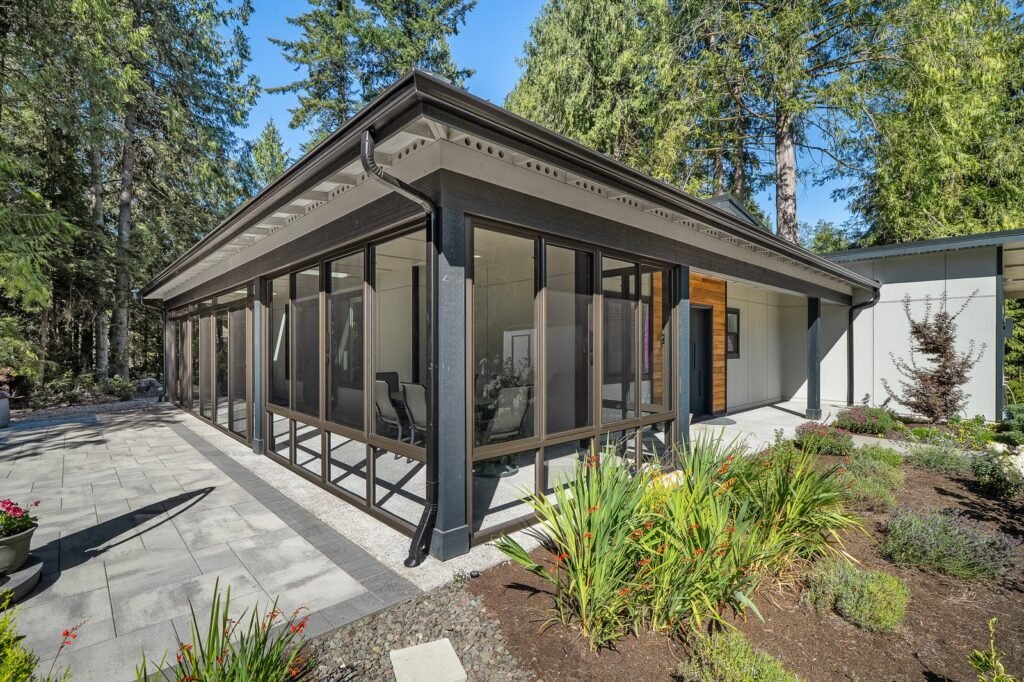 Exterior remodel, modern single-storey home with dark trim and glazing